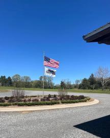 United States and Rabbit Ridge Farms Flag flying in front of Rabbit Ridge Farms